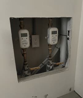 Eddy meters retrofitted into an existing wall recess.
